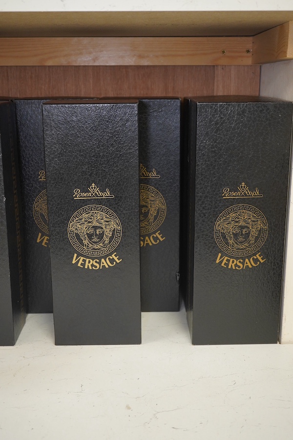 Five boxed Rosenthal for Versace Medusa head glasses; three wine glasses and two champagne flutes in various colours, 30cm high. Condition - good.